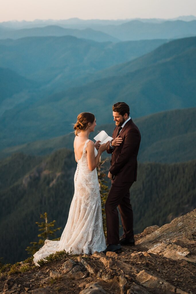 Bride reads vows to groom on a mountain trail near Mount Rainier National Park