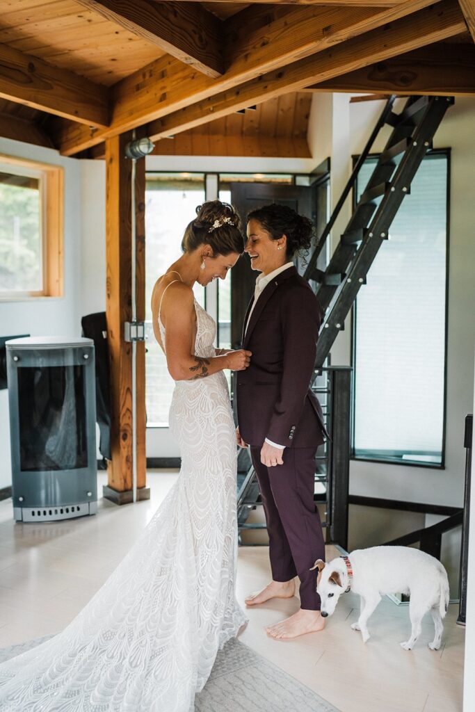 Brides help each other get ready for their LGBTQ elopement in Washington