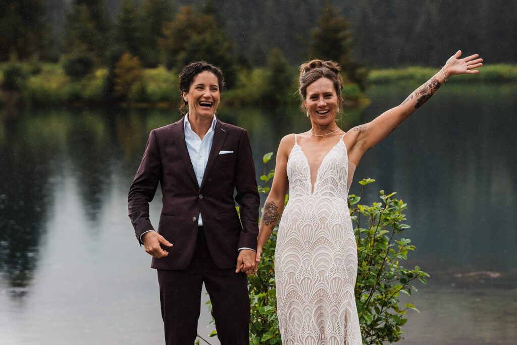 Brides cheer after their LGBTQ elopement ceremony in the rain