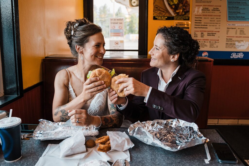 Brides share burgers before going on their sunset hike in Washington