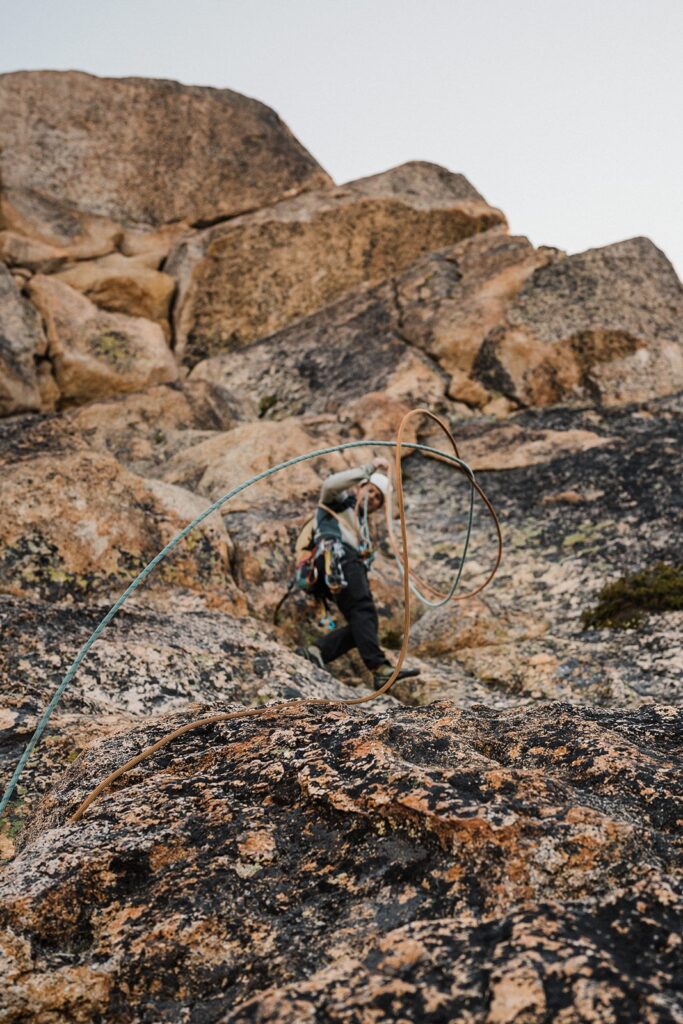 Groom throws a line during his rock climbing elopement in the North Cascades