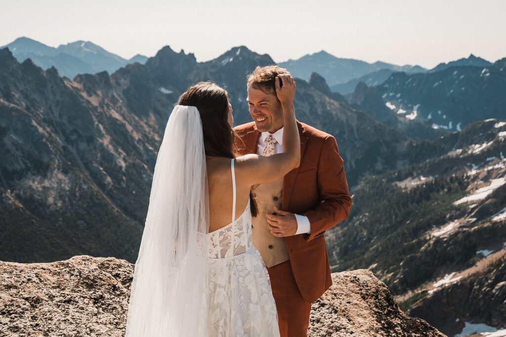 Bride and groom laugh during their elopement first look in the North Cascades