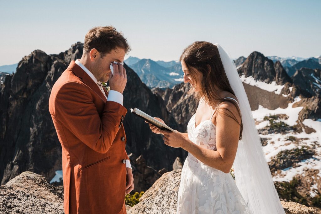 Bride reads private vows and groom gets emotional during their rock climbing elopement in the North Cascades