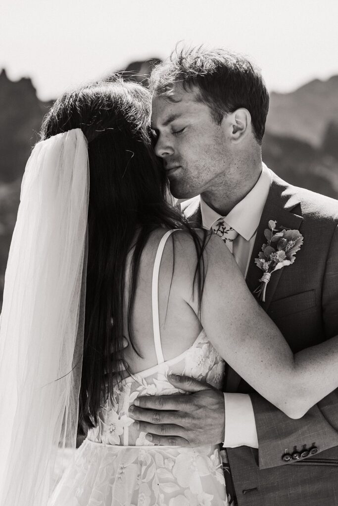 Bride and groom hug during their rock climbing elopement in the North Cascades