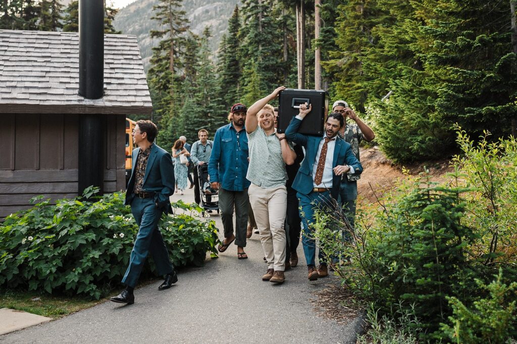 Guests carry equipment to the elopement ceremony location in the North Cascades