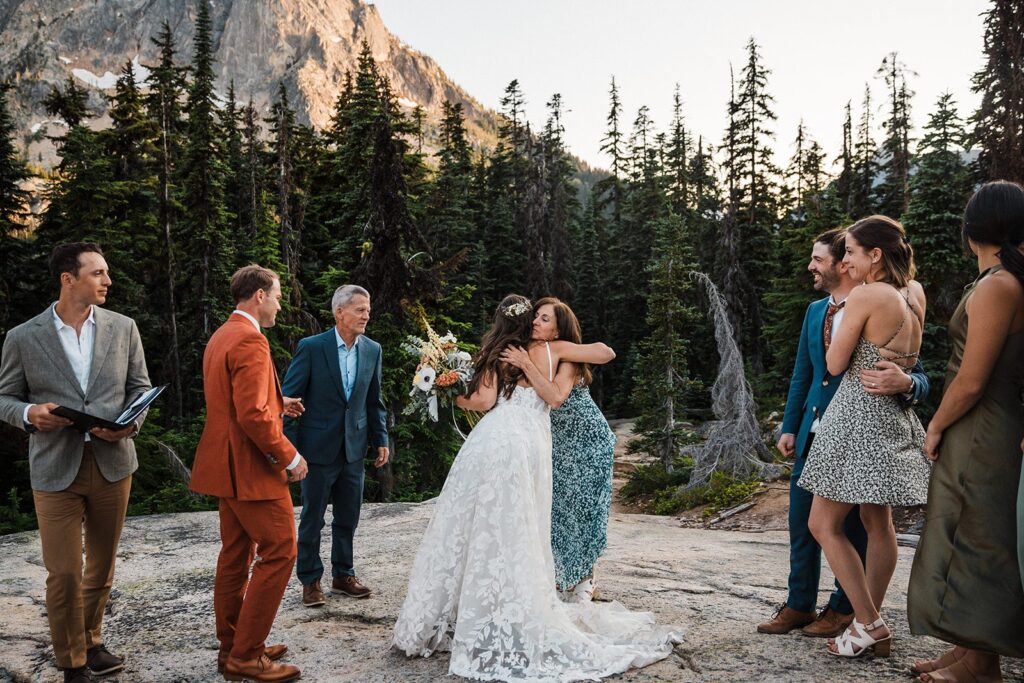 Bride hugs guest during her elopement ceremony in North Cascades National Park