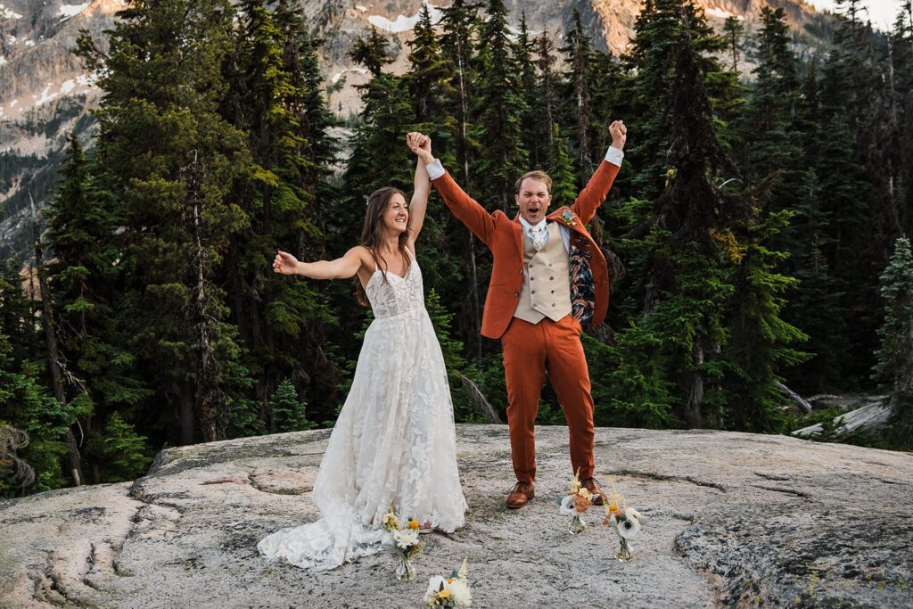 Bride and groom cheer after their North Cascades National Park elopement ceremony with friends