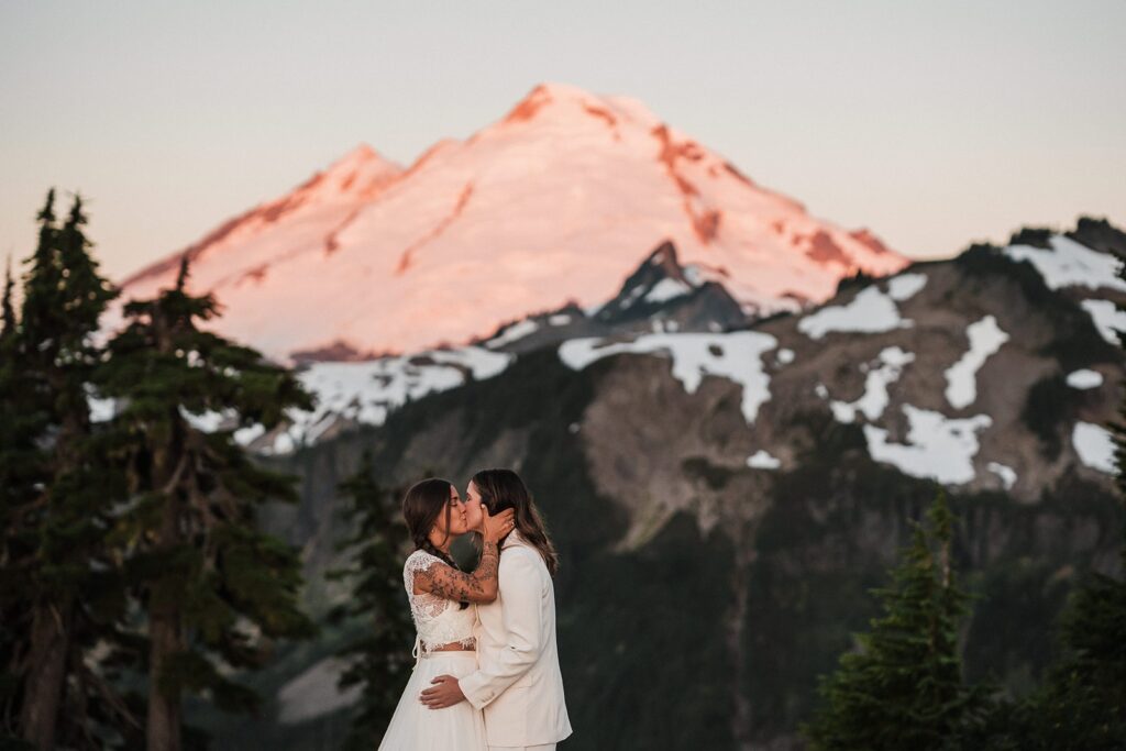 Brides kiss during their Artist Point sunrise elopement first look 