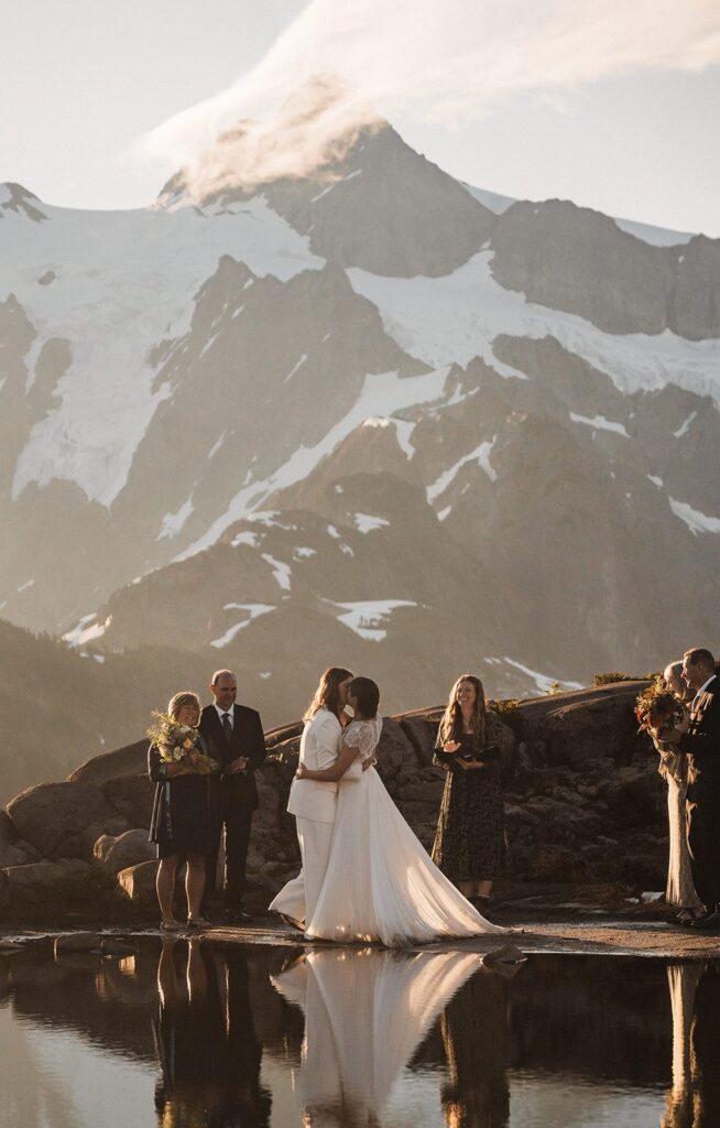 Brides kiss during their elopement ceremony at Artist Point 