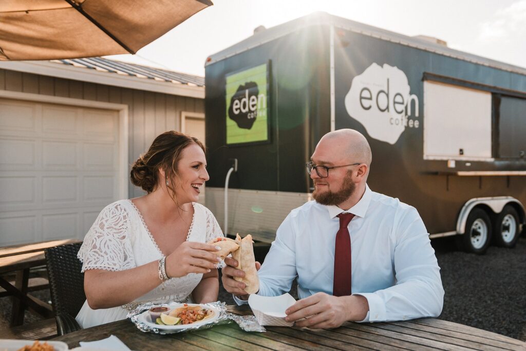 Bride and groom eat burritos at Da Crack during their elopement in Kauai 