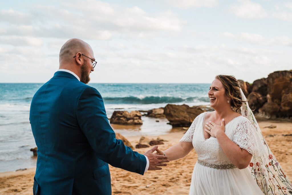 Bride and groom hold hands during their beach elopement in Kauai 