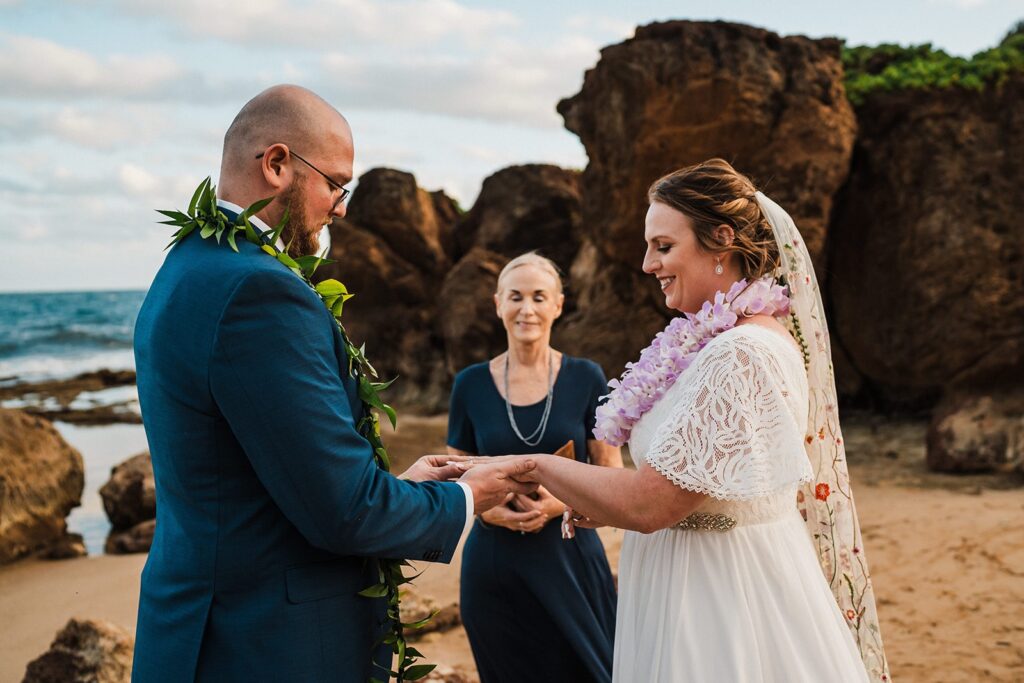 Bride and groom exchange rings during their elopement in Kauai 