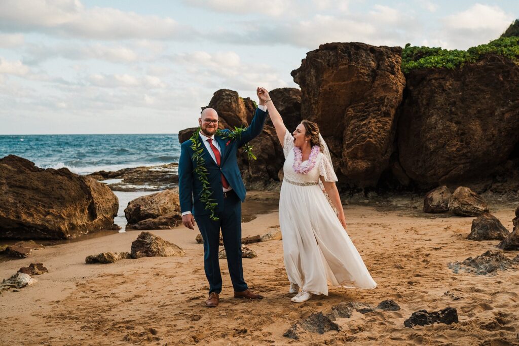 Bride and groom dance on the beach after their Kauai elopement ceremony 