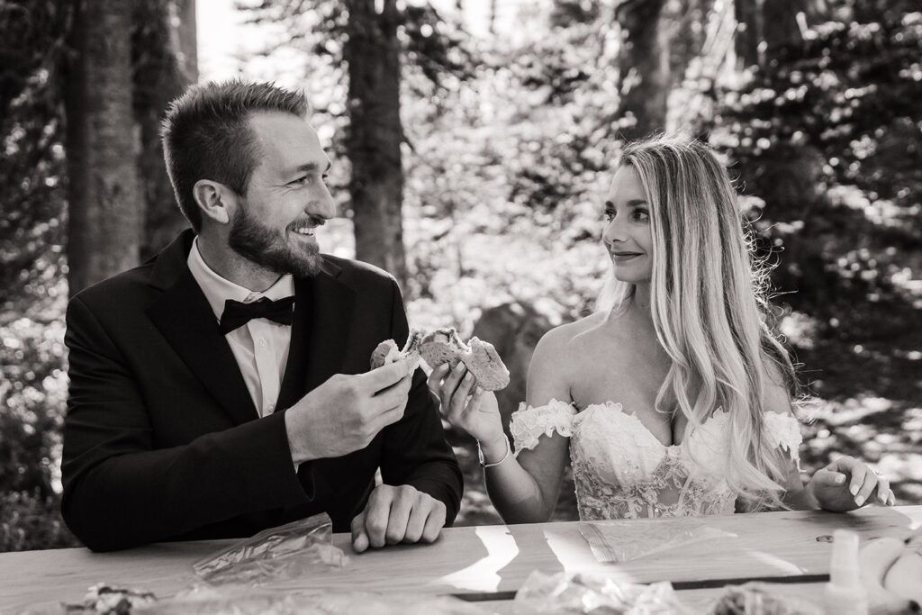 Bride and groom eat peanut butter and jelly sandwiches during their Mount Rainier National Park elopement 