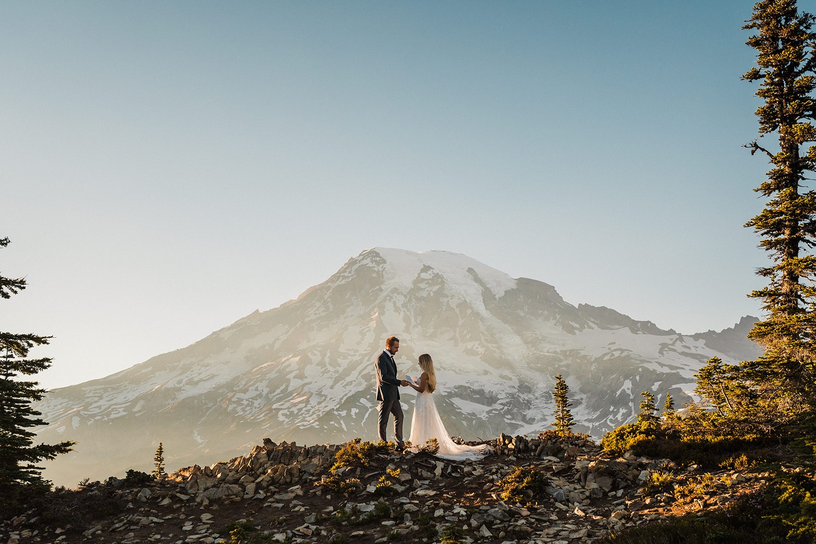 Bride and groom exchange vows on a mountain trail during their elopement at a national park 