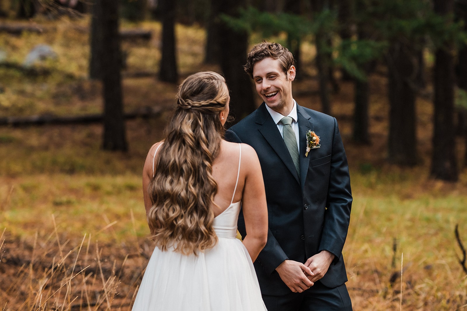 Groom turns around for a wedding first look with bride at their family cabin in Washington