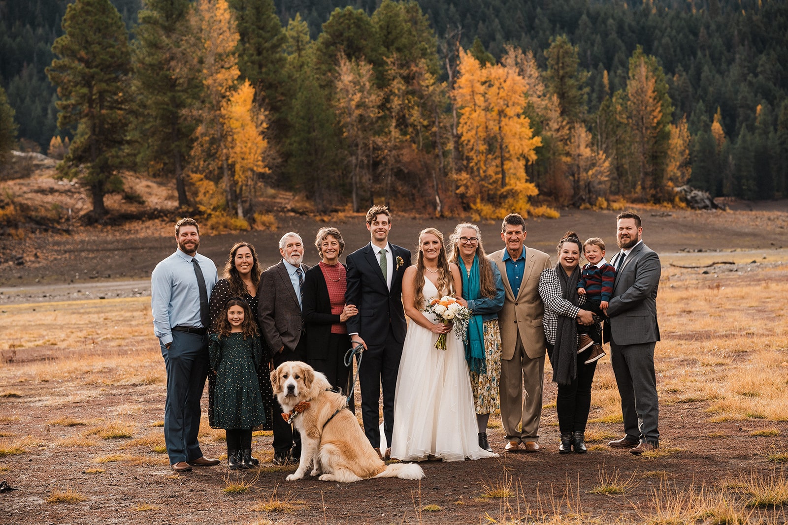 Family fall wedding portrait with bride and groom