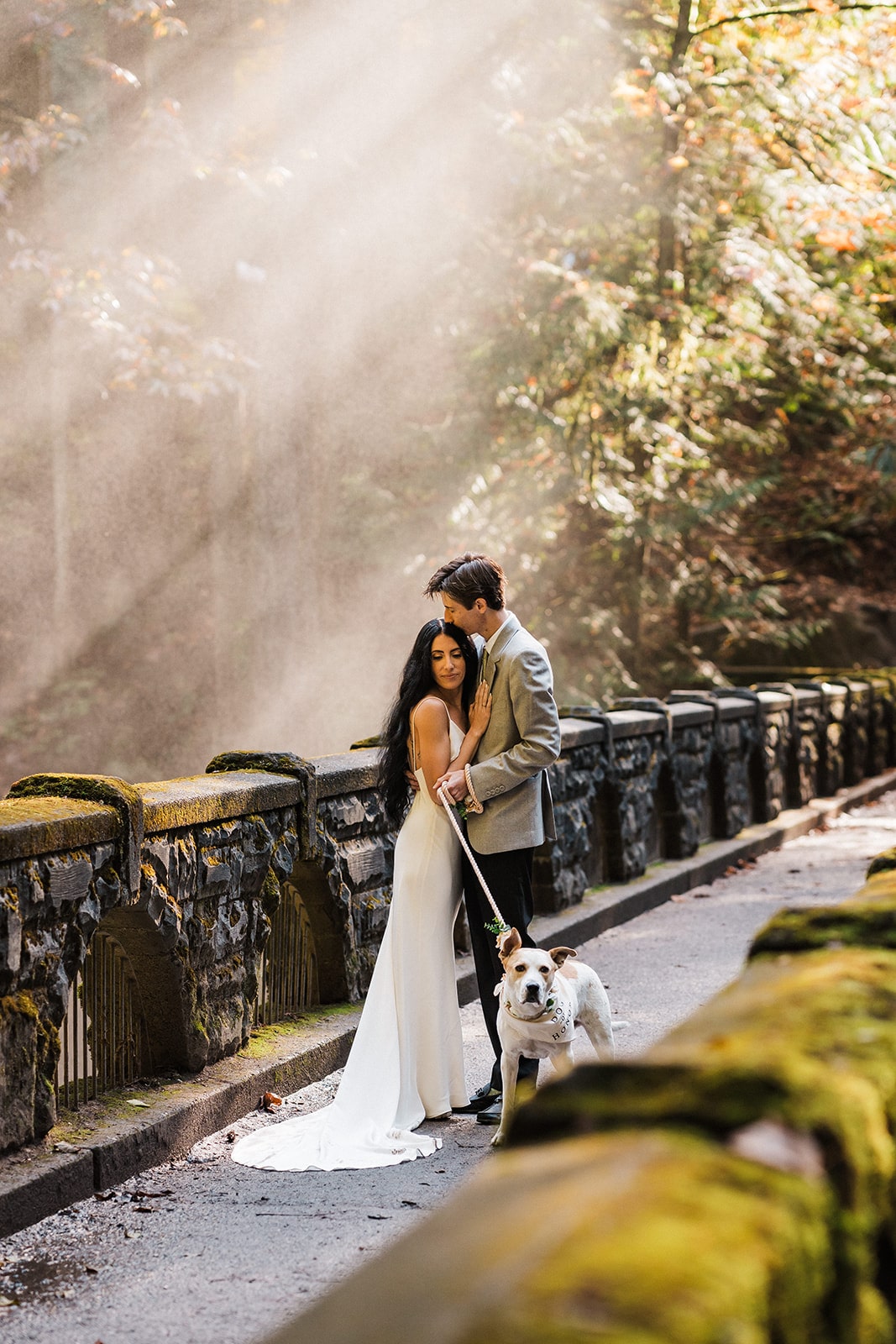 Bride and groom hug on a forest trail during their elopement at Mt Baker 