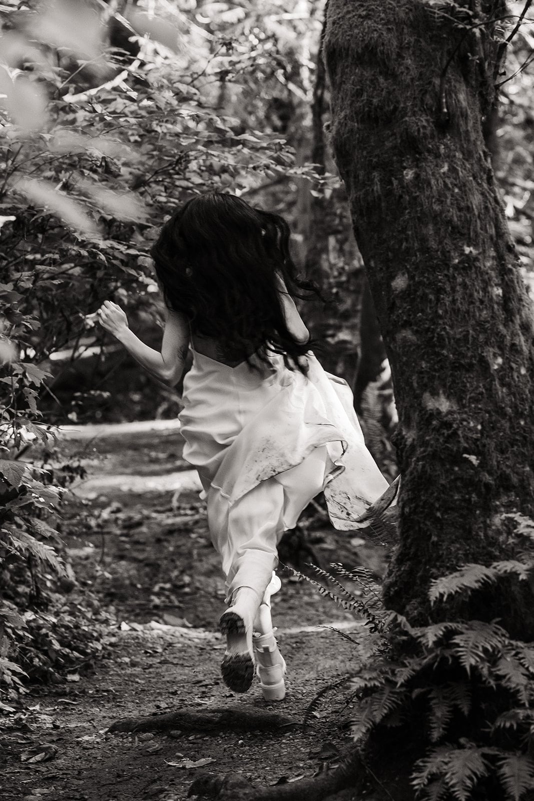 Bride runs through the forest during her Mt Baker Elopement