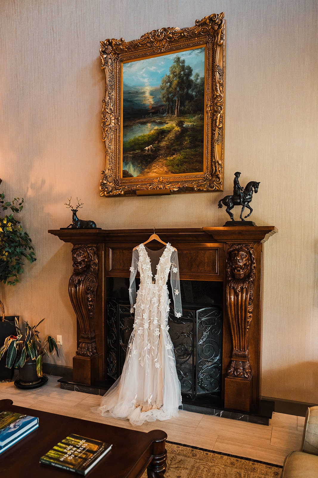 White wedding dress hanging from a fireplace mantel at a hotel in Bellingham, WA