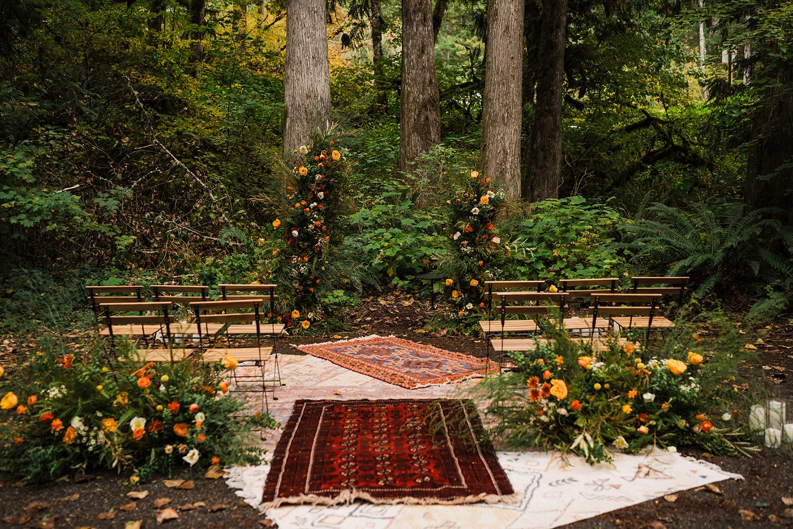 Rugs line the ground at a forest wedding ceremony in Mt Baker