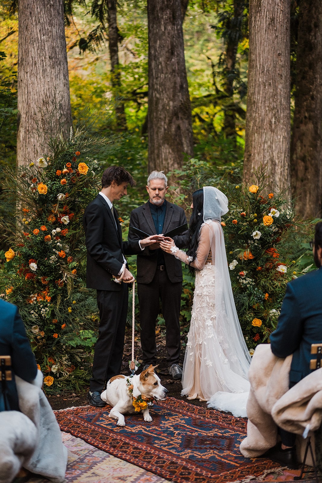 Bride and groom exchange rings during their forest wedding in Mt Baker