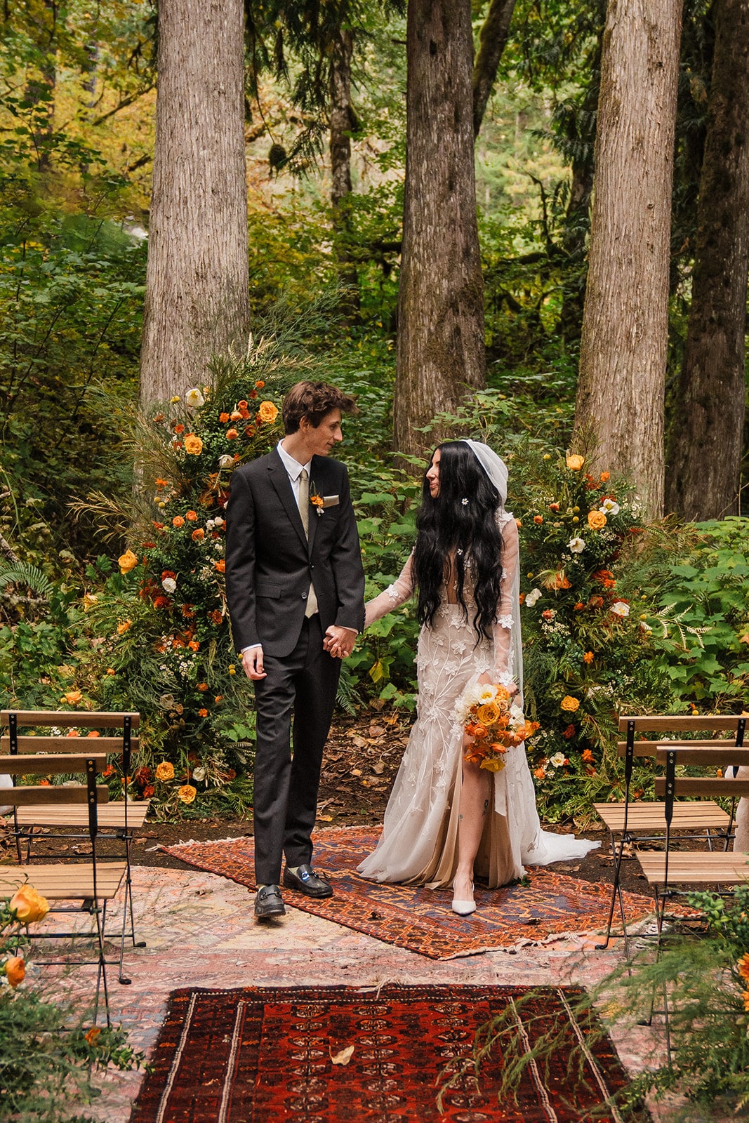 Bride and groom hold hands after their Mt Baker forest wedding ceremony