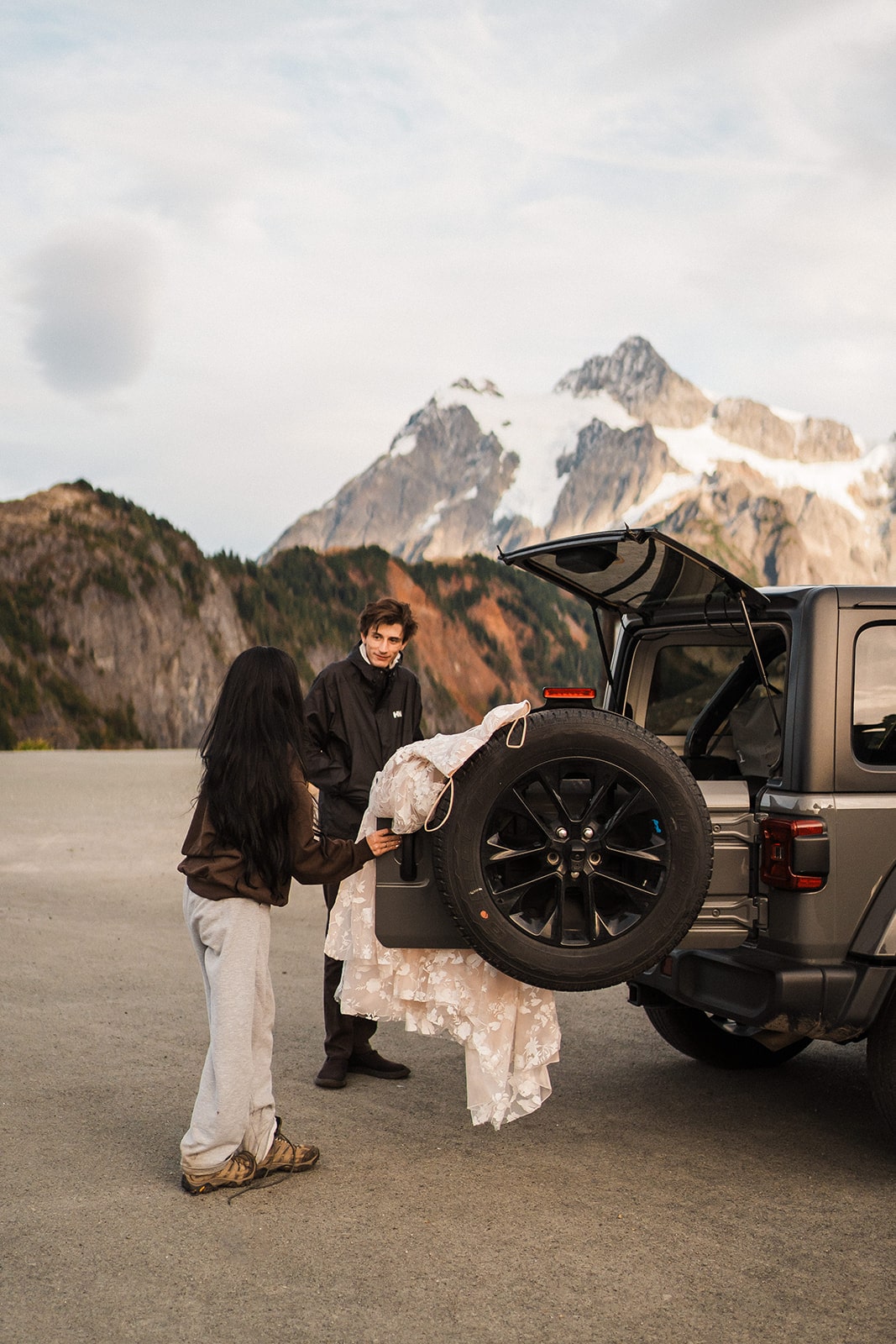 Bride and groom change into their wedding clothes for their adventure photos at Artist Point