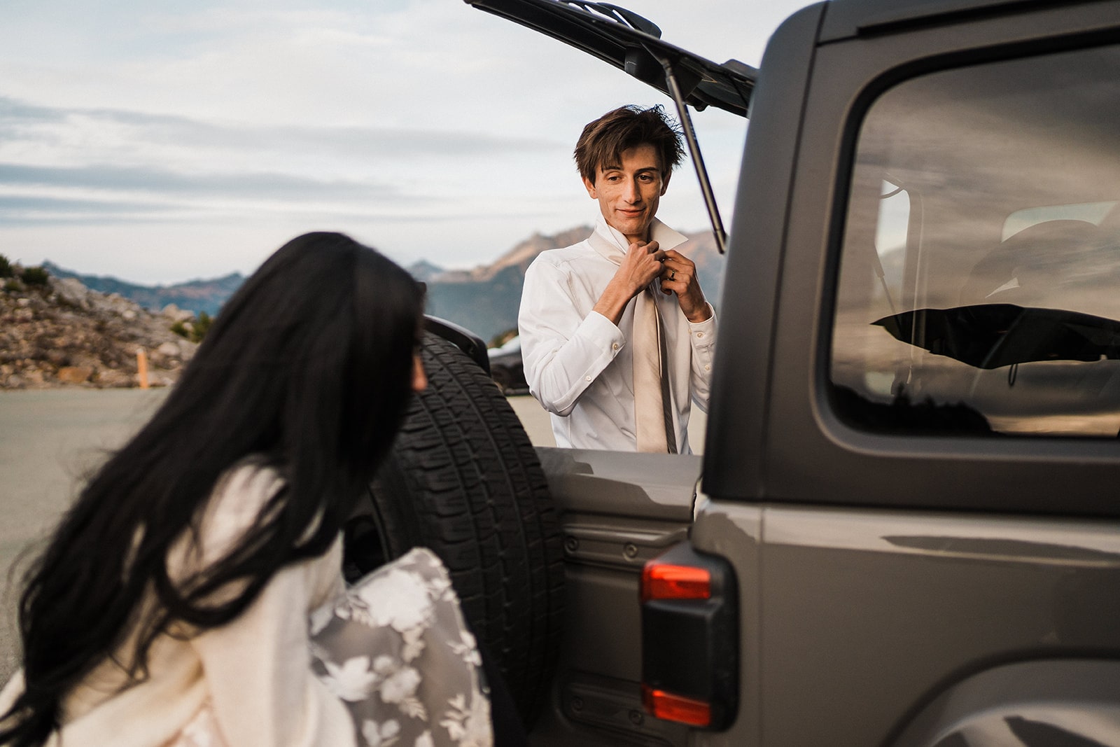 Bride and groom change into their wedding clothes for their adventure photos at Artist Point