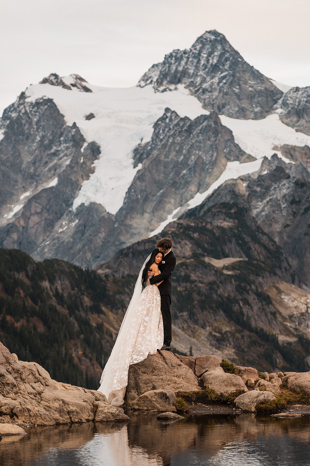 Bride and groom hug on a mountain trail at their Mount Baker elopement 