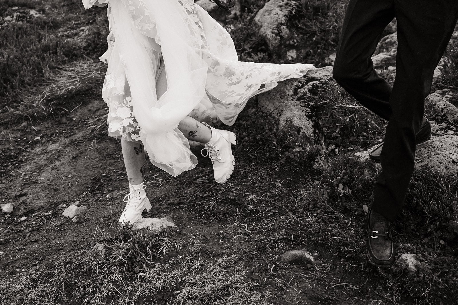 Bride and groom run down a mountain trail during their elopement in Mt Baker