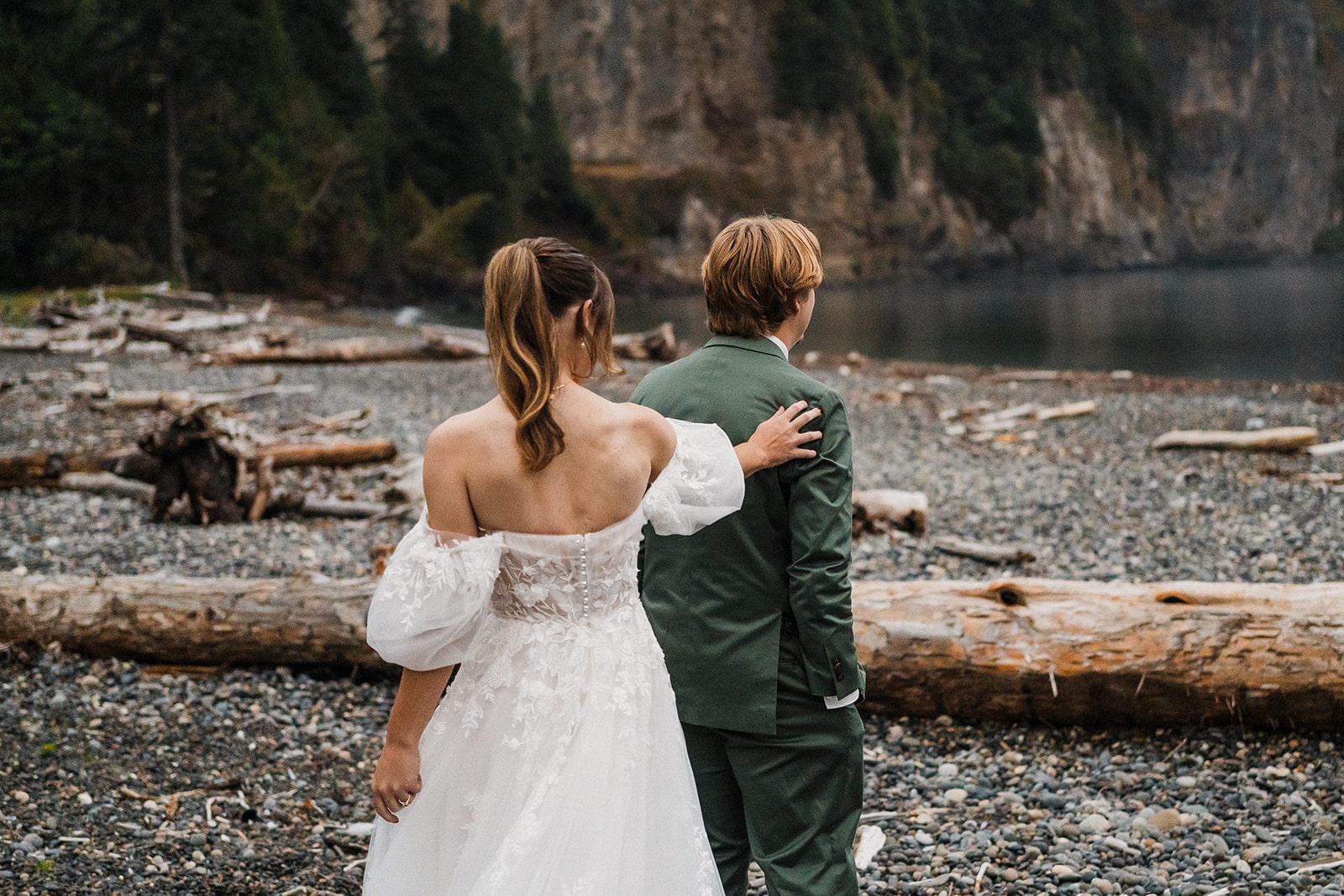 Bride taps groom on the shoulder during their first look at Agate Beach Lodge