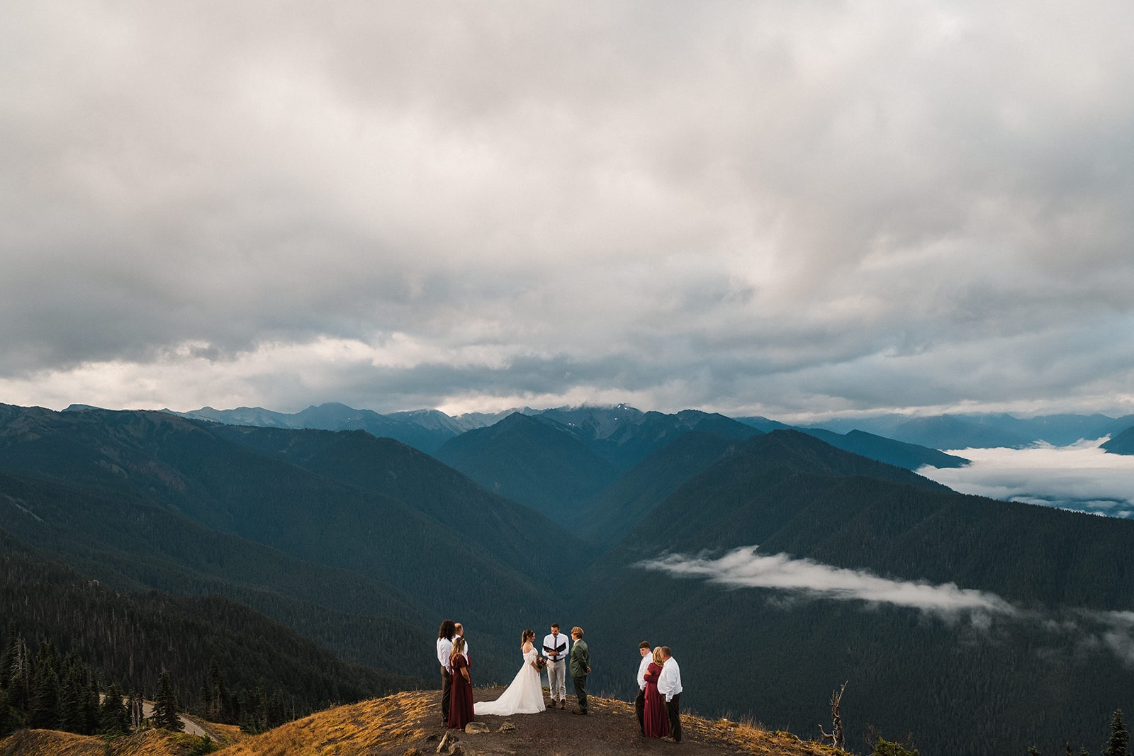 Guests surround bride and groom during their mountain elopement ceremony at Hurricane Ridge