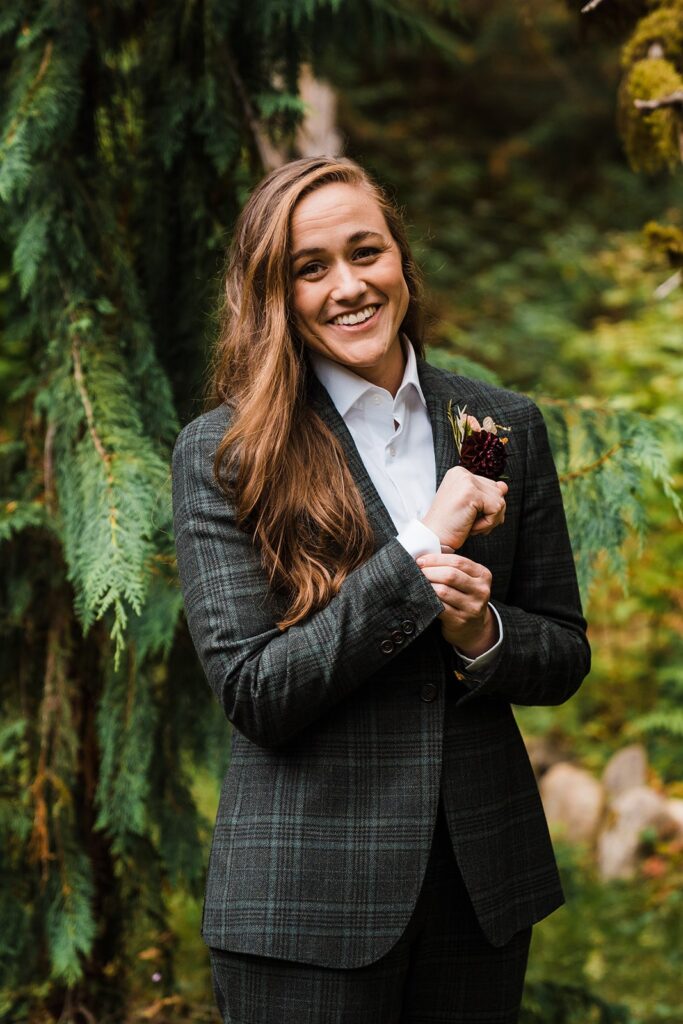 Bride wears a checkered green and gray suit during her adventure elopement in Washington