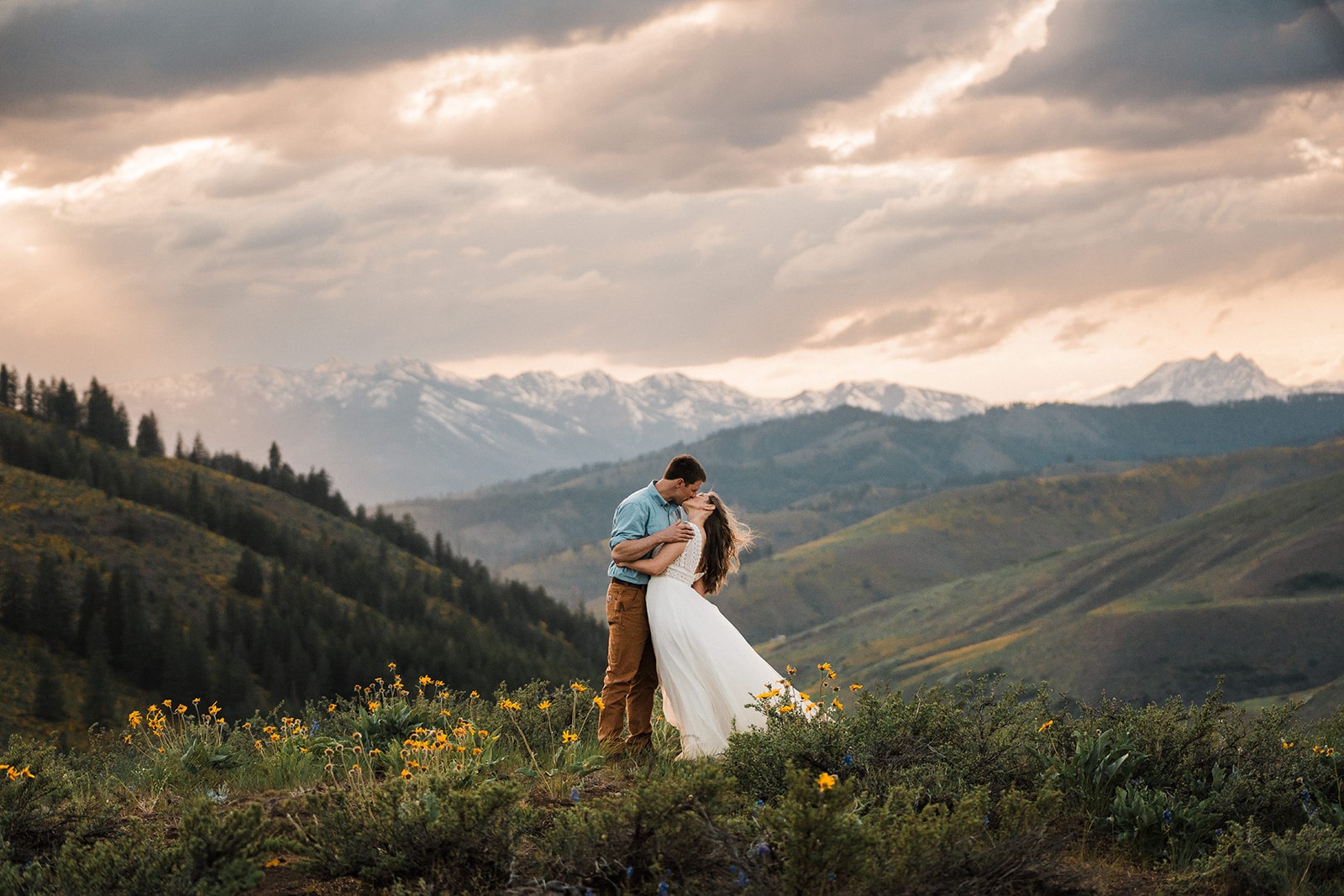 Bride and groom kiss on a mountain overlook during their Eastern Washington elopement.