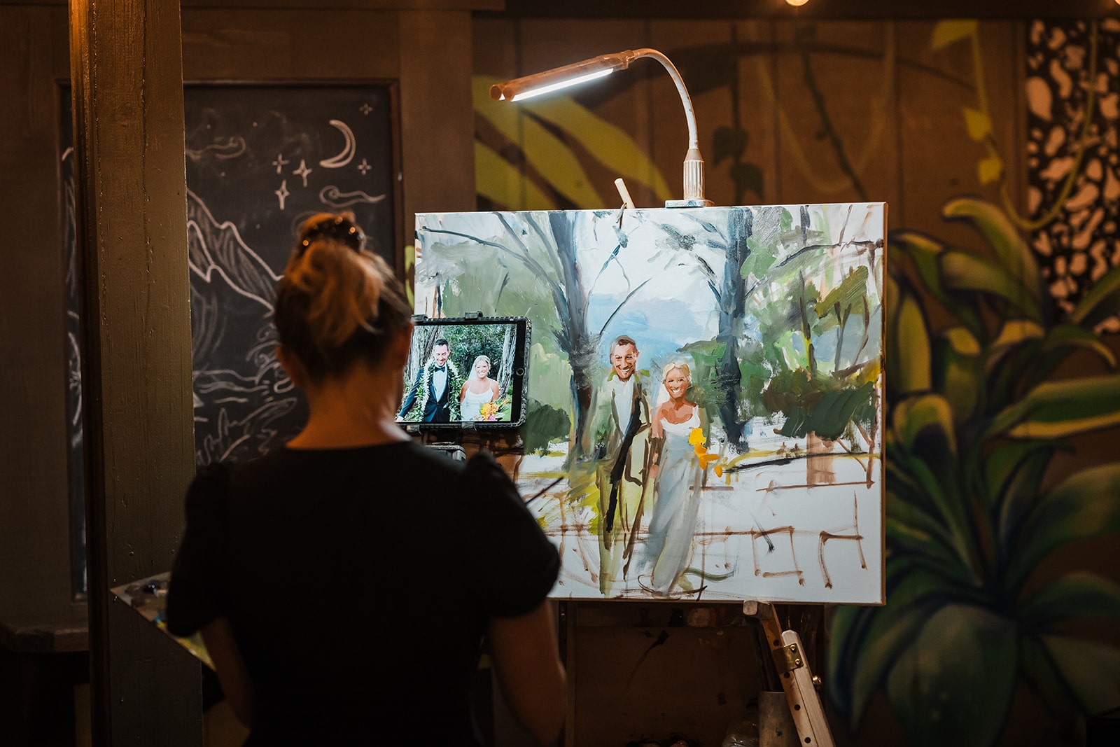 Live painter painting bride and groom at their microwedding ceremony in Kauai.