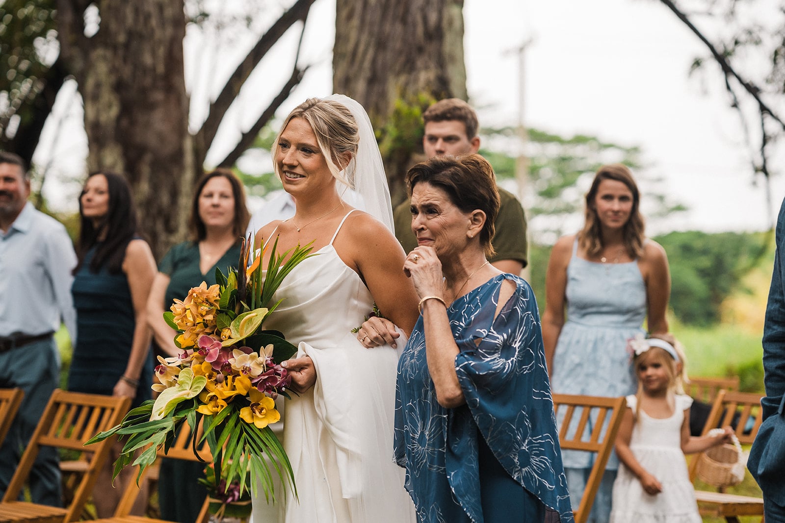 Bride and mother walk down the aisle during a Kauai micro wedding ceremony.
