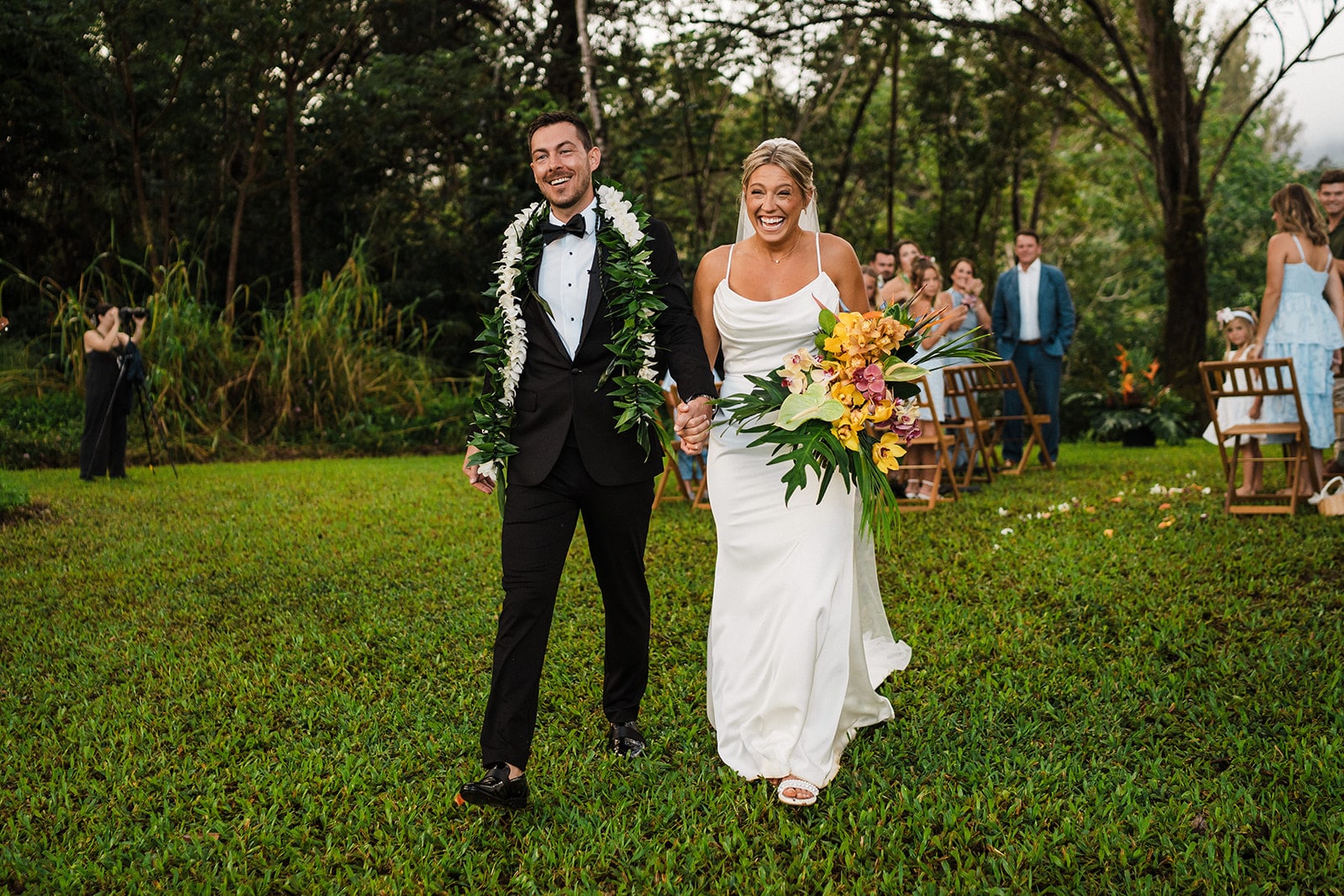 Bride and groom smile as they exit their micro wedding ceremony in Kauai.