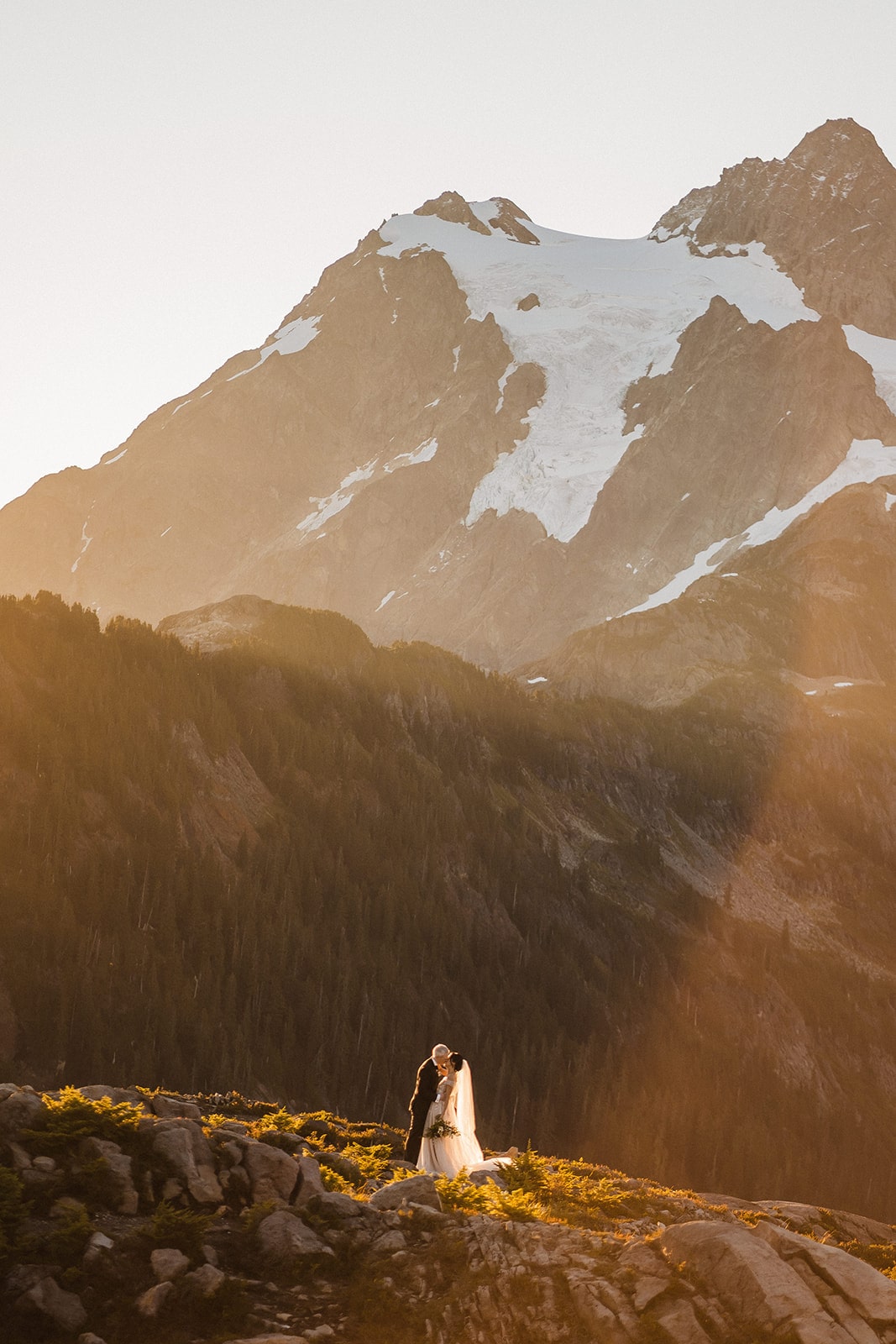 Bride and groom kiss in the mountains during their private adventure session in the North Cascades.