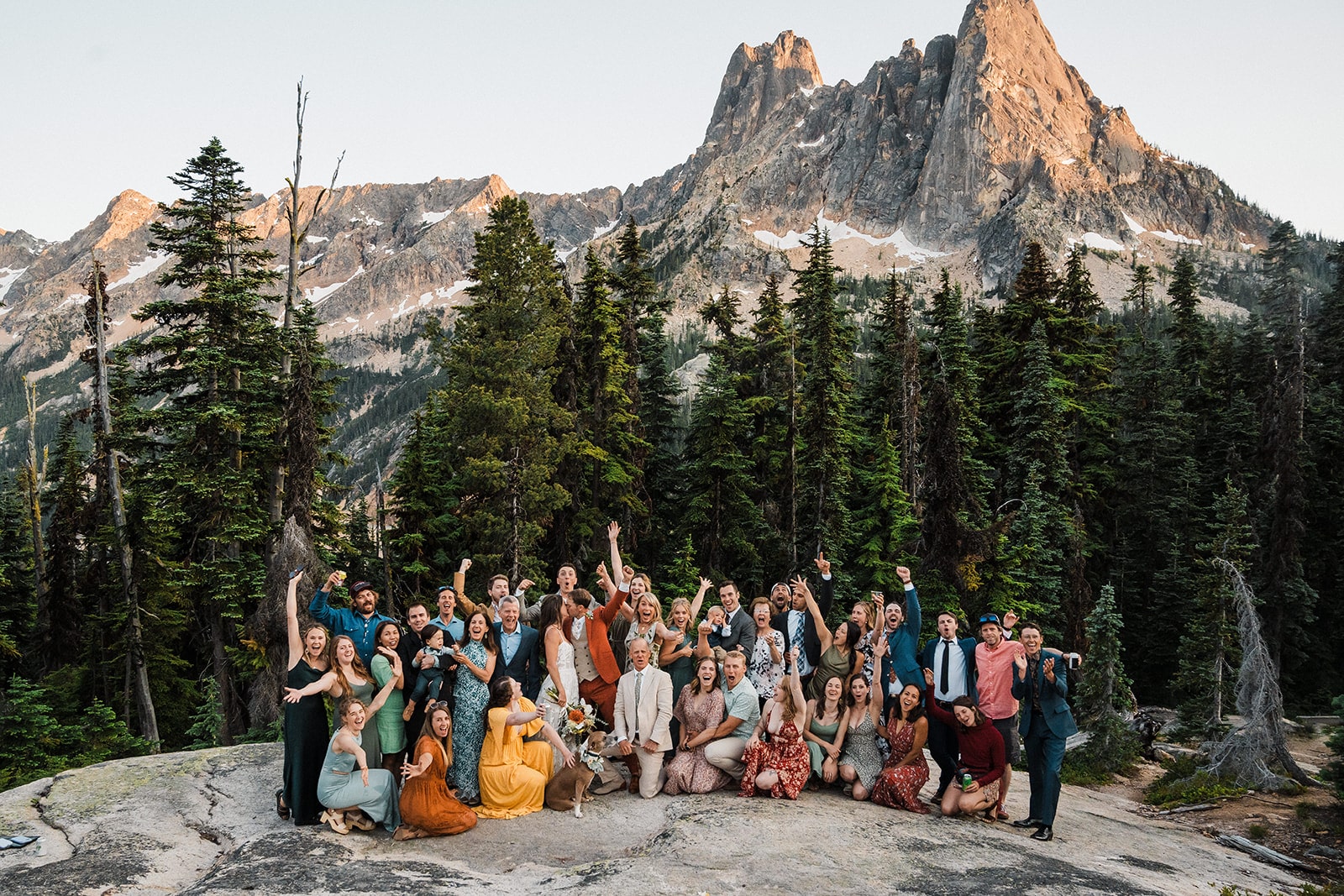 Guests cheer after a wedding weekend ceremony at sunset in the North Cascades.