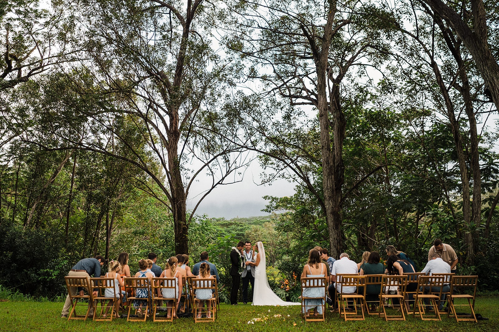 Bride and groom hold an outdoor ceremony at their multi-day wedding in Kauai.