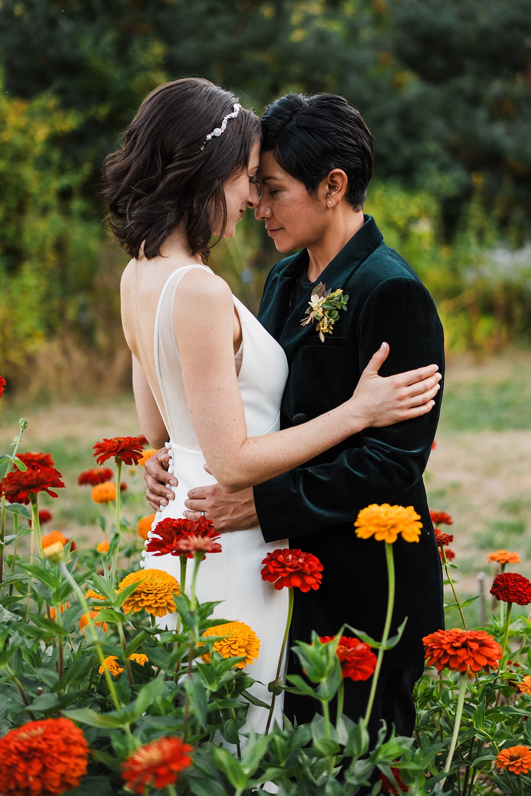 Brides rest their foreheads against each other during their elopement in Washington.
