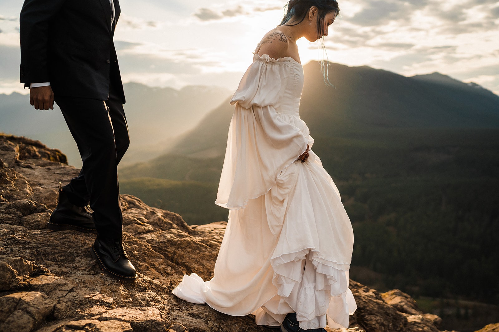 Bride and groom hike down a mountain after sunrise during their Snoqualmie elopement. 