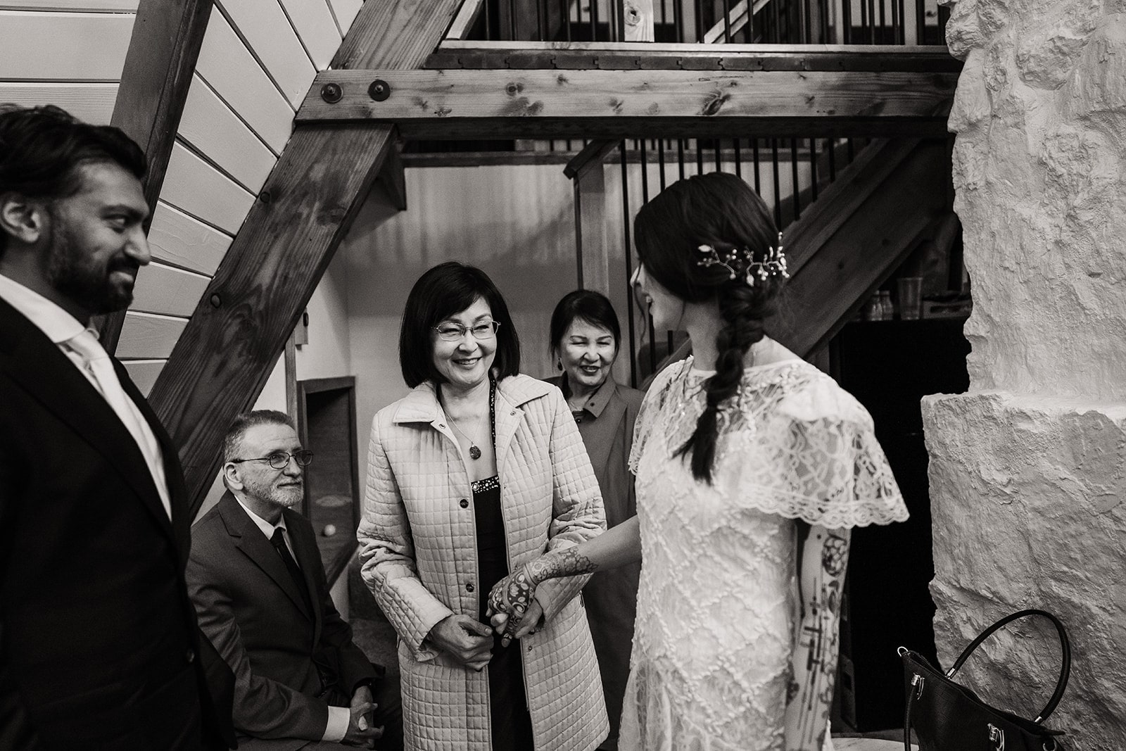Bride's mother smiles at her during their elopement reception revealing the bride wearing her mother's wedding dress. 