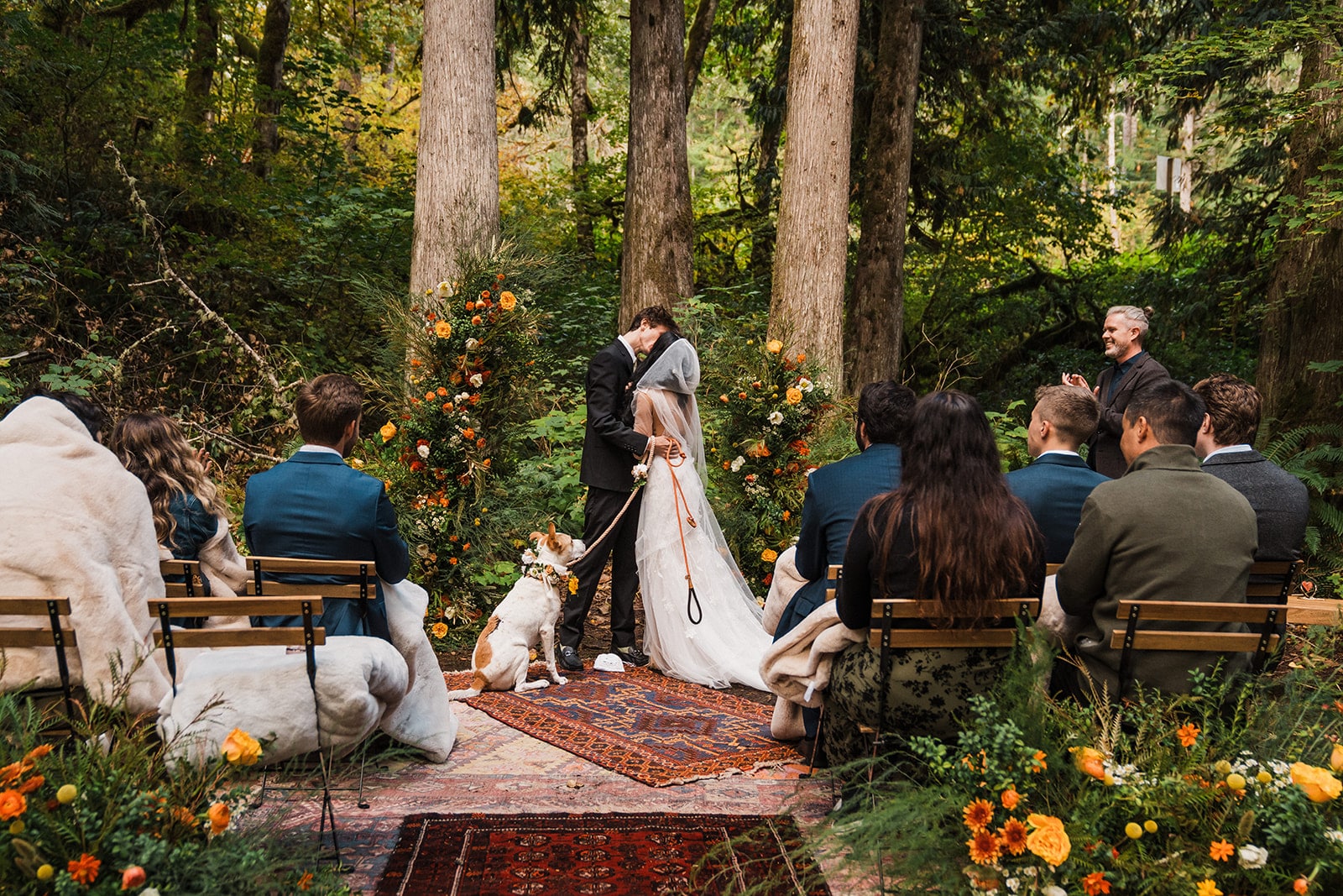 Bride and groom kiss during their forest elopement ceremony at their dog friendly elopement in Washington.