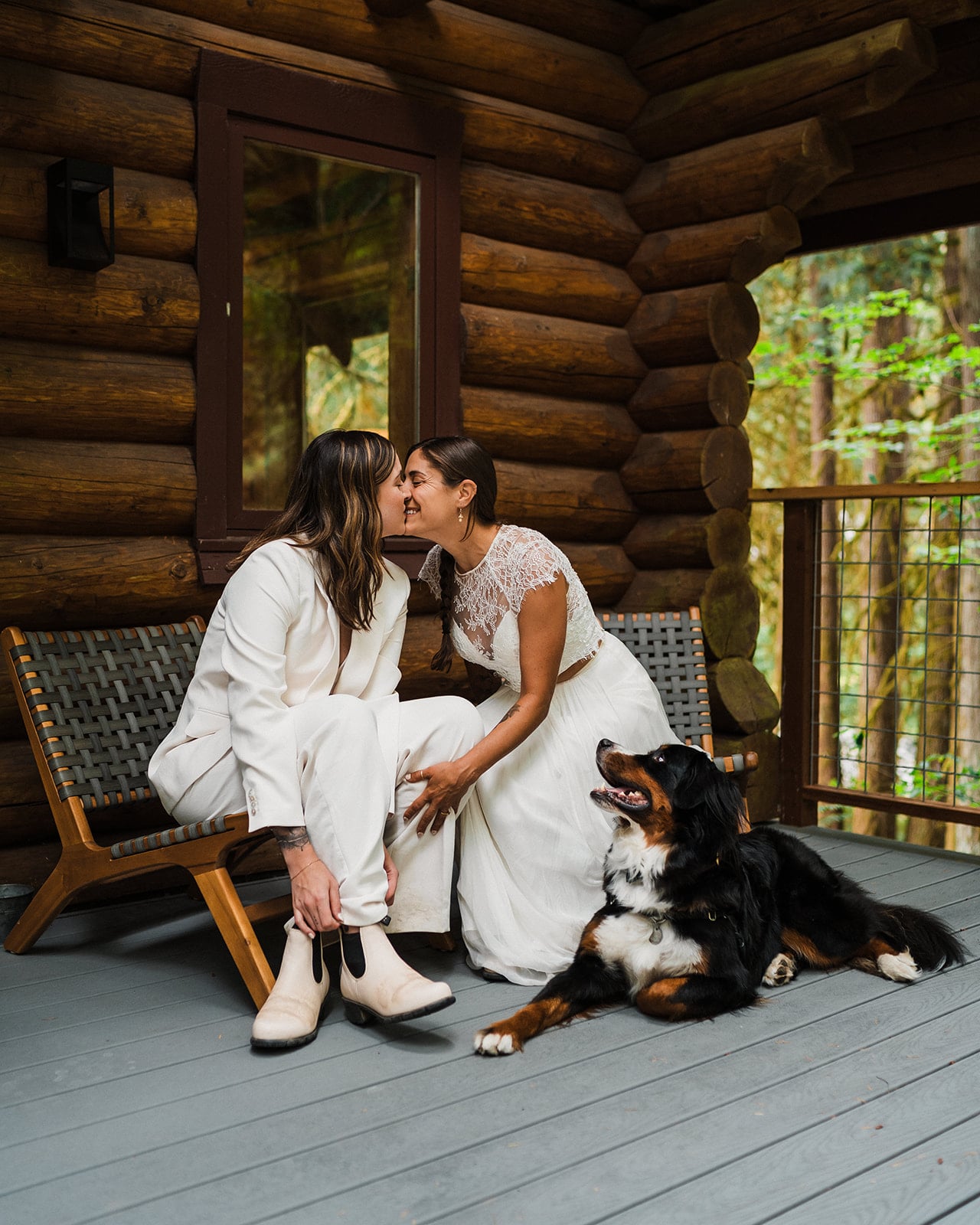 Two brides kiss while getting ready for their hiking elopement in Washington.