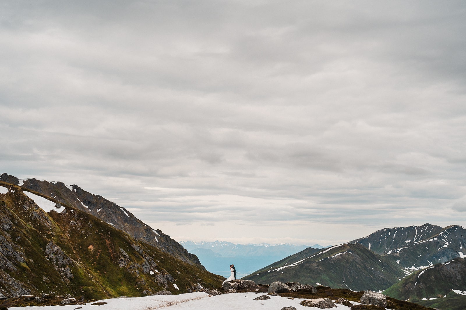 Bride and groom elope in Alaska surrounded by mountains. 