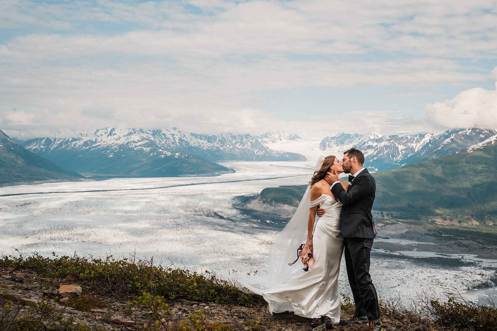 Bride and groom kiss on a glacier in Alaska during their Palmer elopement.