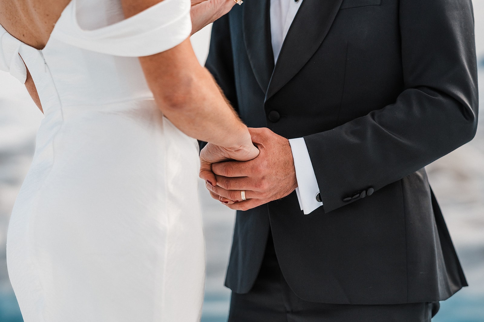 Bride and groom hold hands during their summer Alaska elopement ceremony on a glacier.
