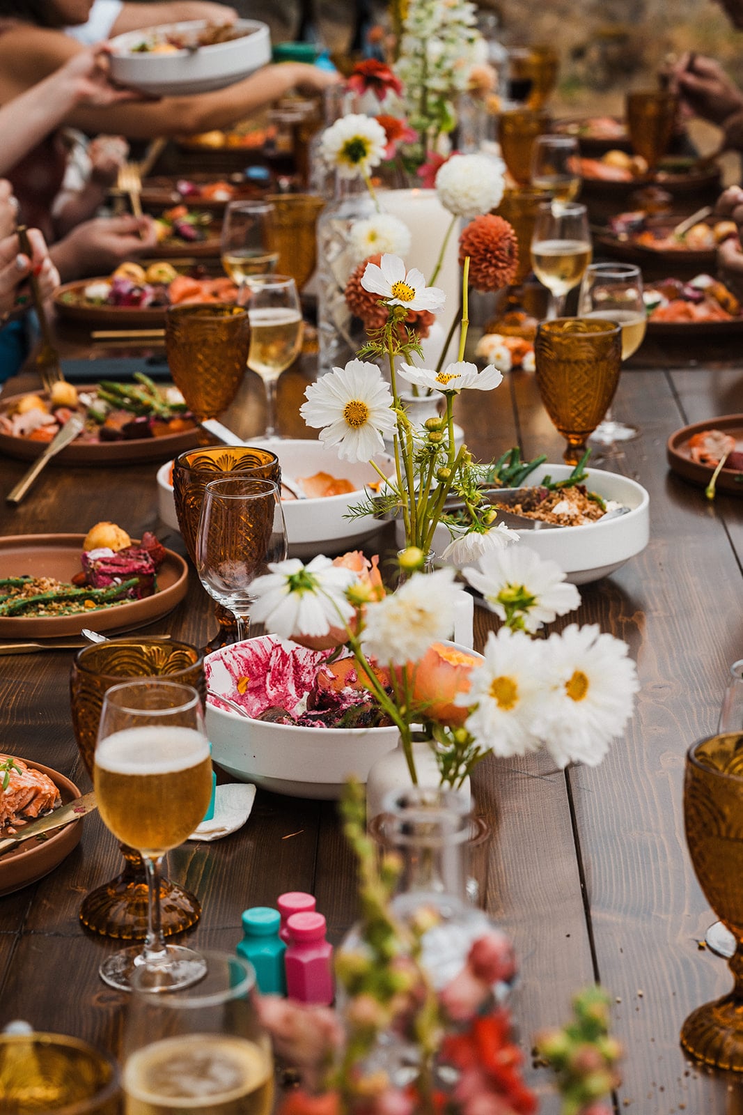 Colorful wildflowers line the center of a micro wedding reception table in Washington. 